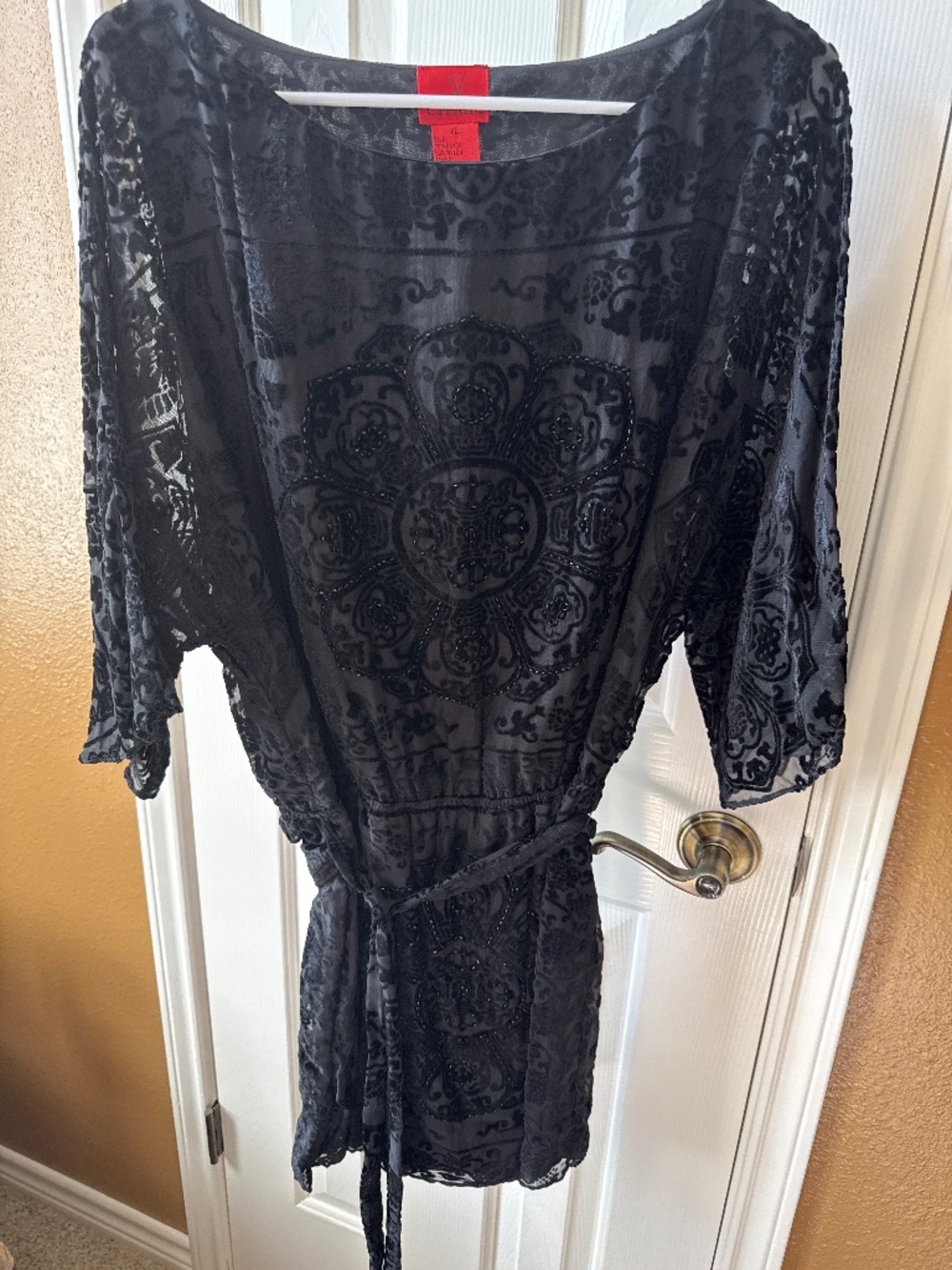 Black patterned top with beads.